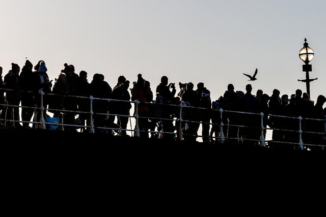 People watching from the safety of the shore as bathers enjoy the Whitby Lions' Boxing Day Dip.