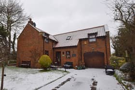 A long driveway leads to the house and integral garage.