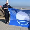 Councillor Barbara Jefferson and Jonathan Newman, foreshores inspector, proudly display the Blue Flag for Hornsea.