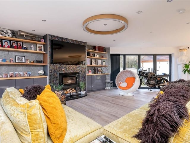 The open plan design includes this modern fire setting and under floor heating.