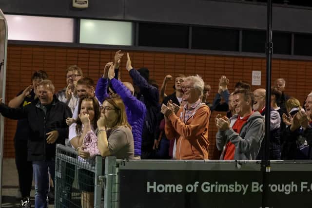 Bridlington fans cheer the players off at full time at Grimsby Borough. Photo by EC Media