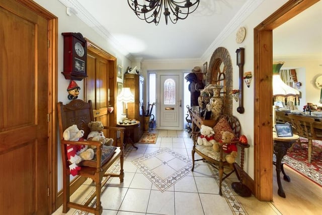 The hallway has an arched feature window with exposed brick surround.