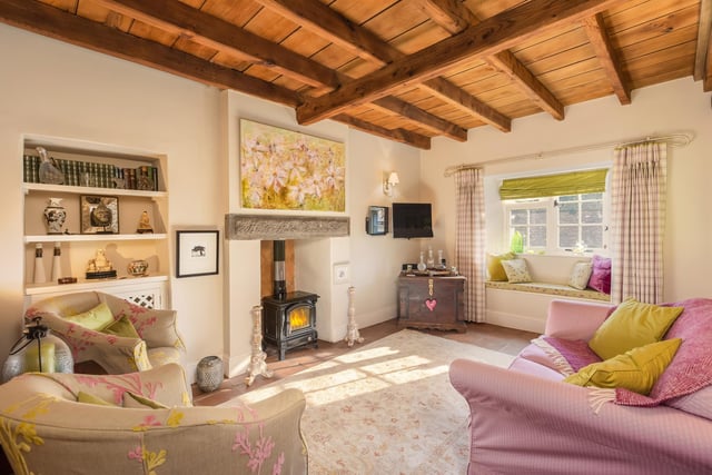 The beamed sitting room with wood burning stove.