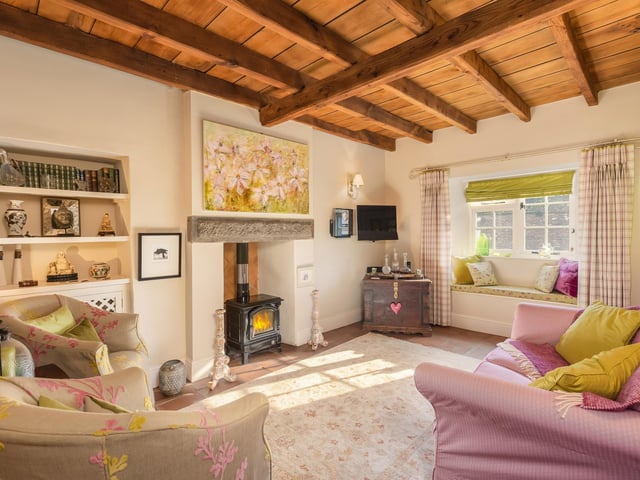 The beamed sitting room with wood burning stove.