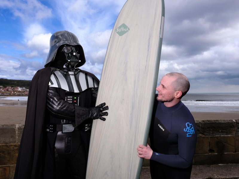 Leeds Surfer Jamie Robinson offers his board to Darth Vader.