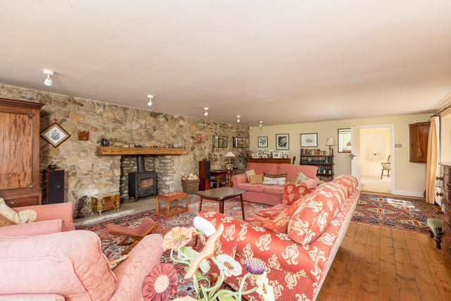 A feature stone wall and fireplace within the large and comfortable lounge.