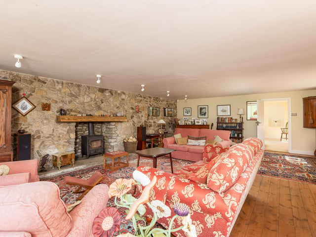 A feature stone wall and fireplace within the large and comfortable lounge.