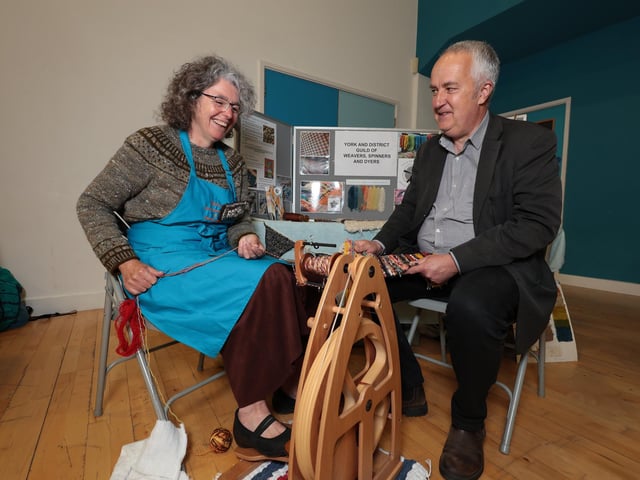 Rachel Benson works the spinning wheel with organiser David Stone