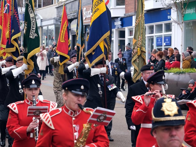 The standard bearers following the band