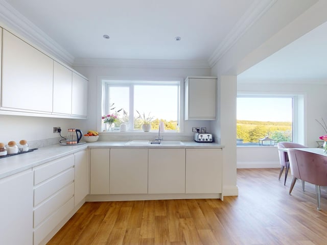 Modern base and wall units and an island feature give the kitchen space and style.