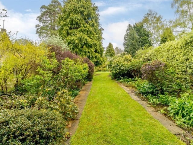 Plant and shrub-filled borders line path and walkways in the gardens.