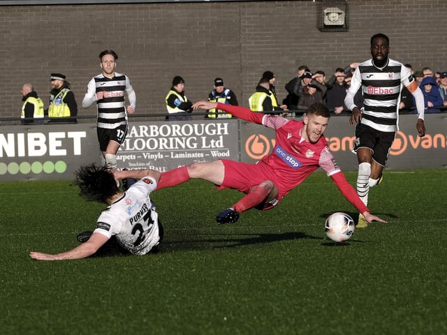 Boro's Kieran Glynn is sent flying by a Darlington challenge.