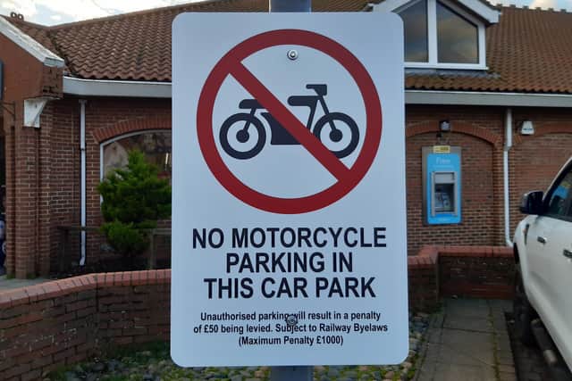 The sign which states motorcyclists cannot park in the car park next to Whitby Railway Station.