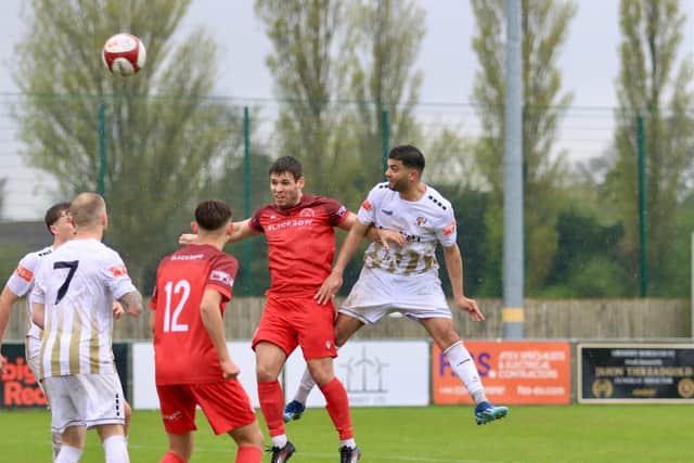 Bridlington Town earned a crucial 2-0 win at Grimsby Borough to seal their NPL East Division survival.
