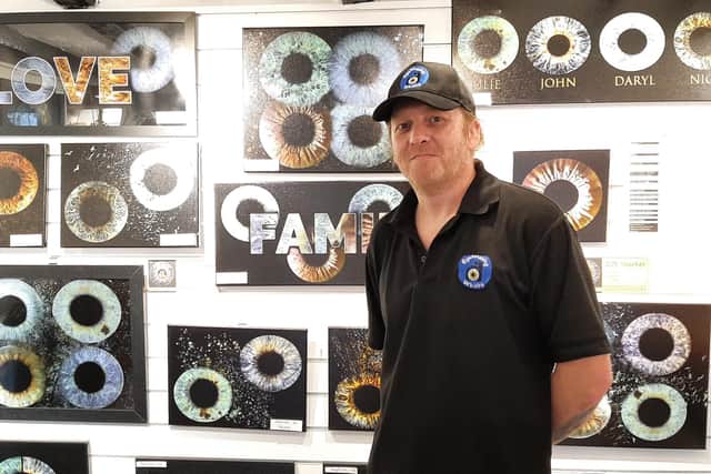 Chris Evans with some framed examples of some of his iris photography.