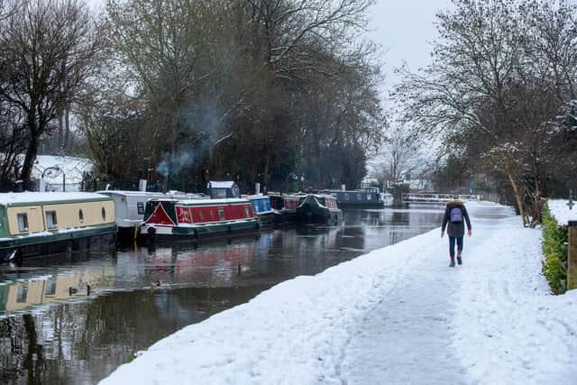 House boats on the Leeds Liverpool Canal at Crossflatts, Bingley, after heavy snow at Christmas 2020