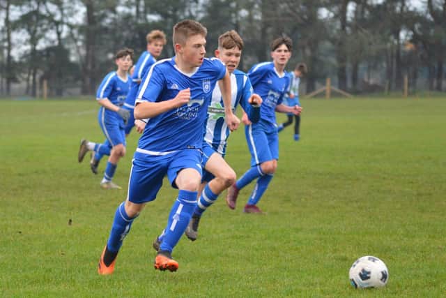 Heslerton Under-15s (blue) battle it out with York RI. PHOTOS BY CHERIE ALLARDICE