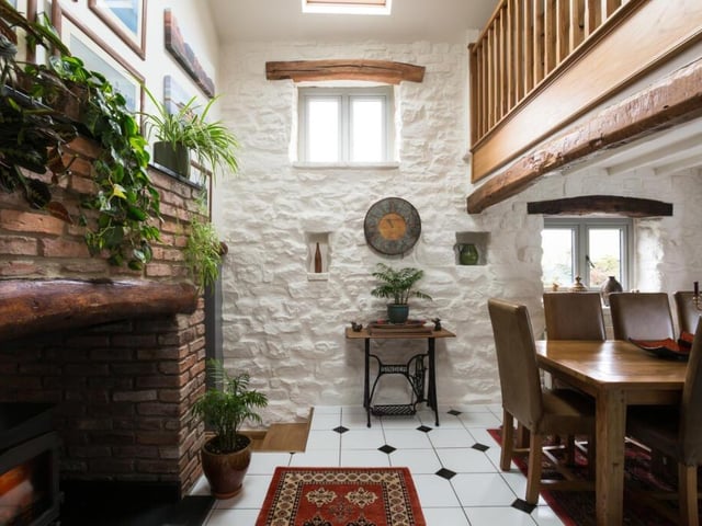 Rustic tones in this dining room with feature brick fireplace and rural views.