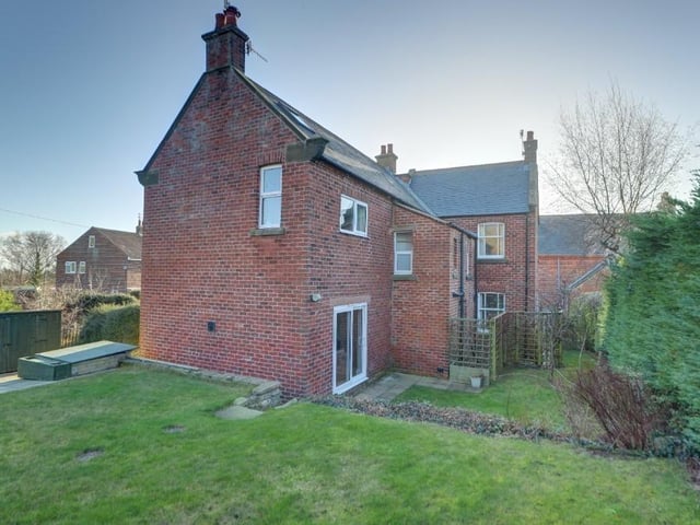 A view of the house from the lawned side and rear garden.