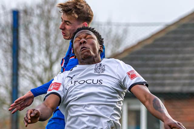 Aaron Braithwaite tries to win a header for Town against Marine.
