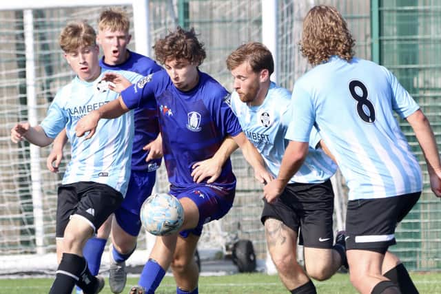 A Pandas player is surrounded by Hessle players.