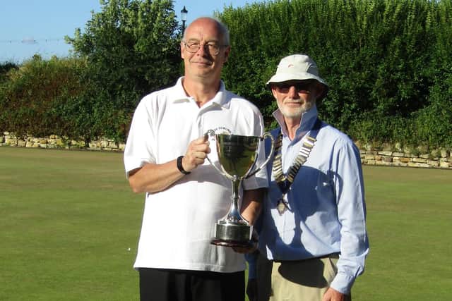 Whitby captain Peter Harvey receives the cup from Ed McCormack