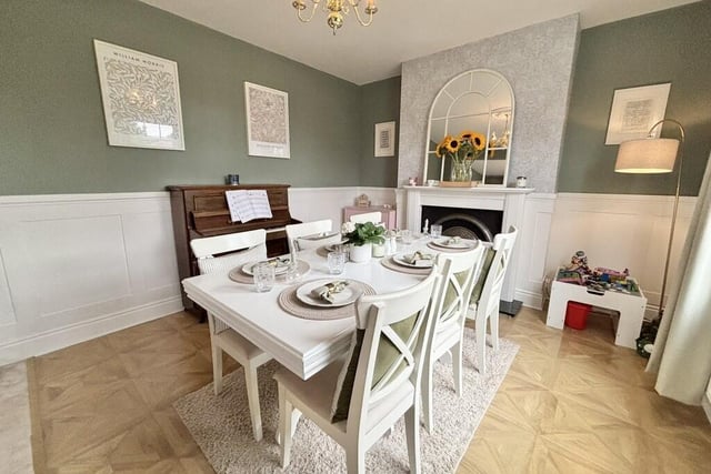 The fireplace within the dining room has a wooden mantelpiece, granite hearth and cast iron inset.