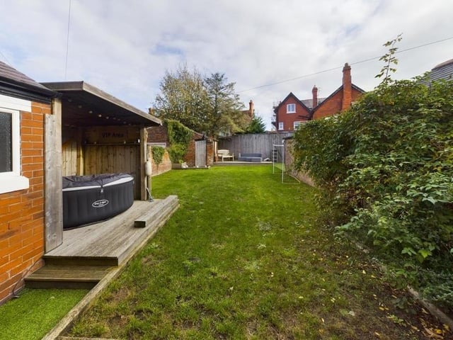 The rear garden has seating areas and a gazebo.