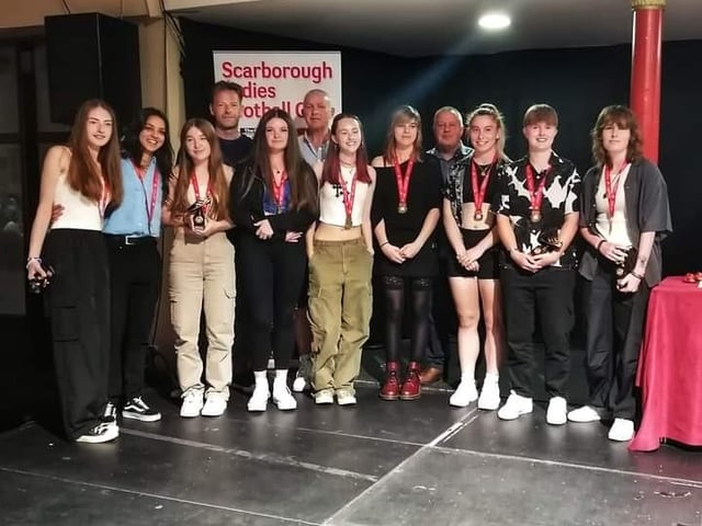 The Scarborough Ladies FC Under-18s pick up their medals and awards.