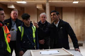 Britain's Prime Minister Rishi Sunak talks with trainees during a visit of the Construction Skills Village in Eastfield, near Scarborough, England.  
Photo by Darren Staples-WPA Pool/Getty Images.