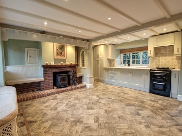 An alternative view of the beamed kitchen with diner, that has fitted wooden units with Quartz worktops. An electric Aga is included in the sale.