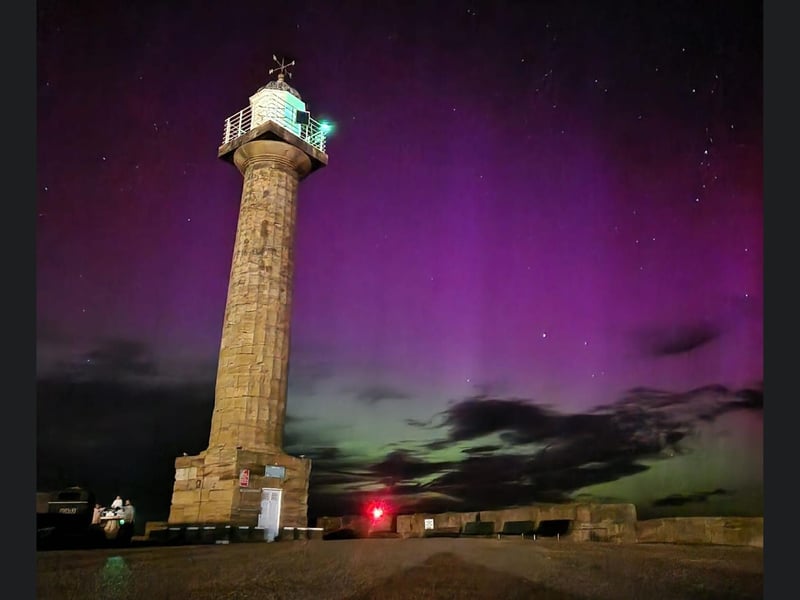 West Pier Lighthouse in Whitby is framed by the gorgeous lights.