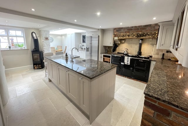 The high spec, open plan kitchen with a central island and breakfast bar