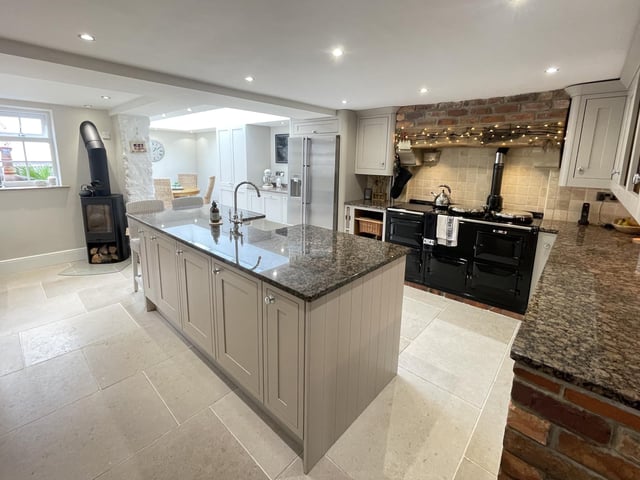 The high spec, open plan kitchen with a central island and breakfast bar