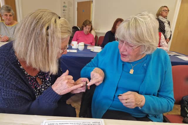 Sandra Hunt-Brown and Barbara Baker from Hinderwell examine a piece of Whitby jet.