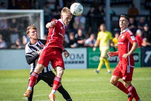 Jack Waldron heads the ball away at Chorley. Photo by Ben Gordon
