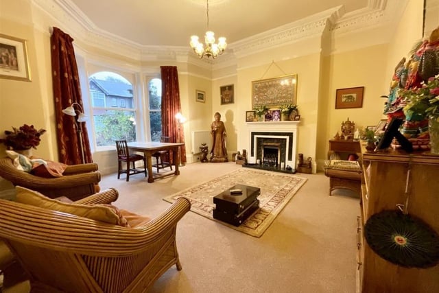 The large bay window lights up the lounge with feature fireplace.