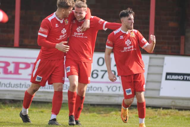 Matt Broadley is congratulated by his Seasiders teammates after his winning goal in the final match of the season.