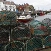 Crab and Lobster pots  stacked high on the quayside of Whitby harbour