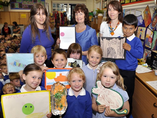 Gladstone Road Infants School are awarded a Gold Artsmark. Back (from left) teaching assistant and artist Sam Barnes, headteacher Anne Swift with the award and art subject teacher Philippa Leighton with some of the year one and reception pupils and their artwork. 102801