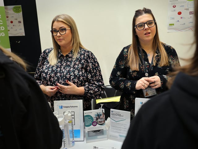 Happy Futures staff speak to visitors