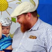 Happy Yorkshire Day - Father and son celebrate the day at Kirkgate Market, Leeds, sporting traditional flat caps