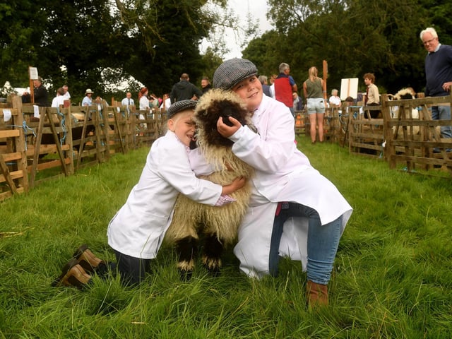 Jorja Coates, five (left), and Missy Coates, nine, from Robin Hood's Bay pictured with their Valais blacknose sheep called Legacy