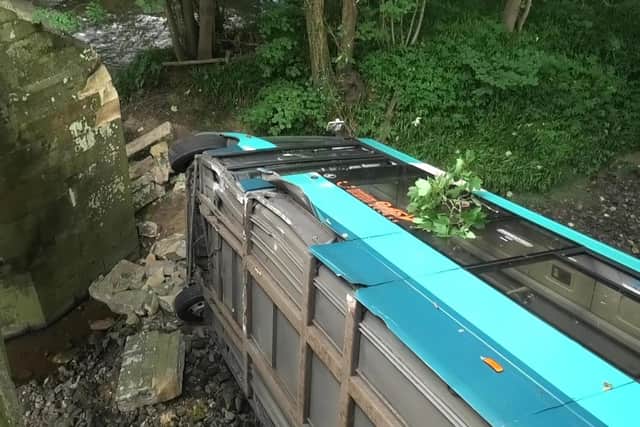The bus on its side after crashing into the river at Grosmont.