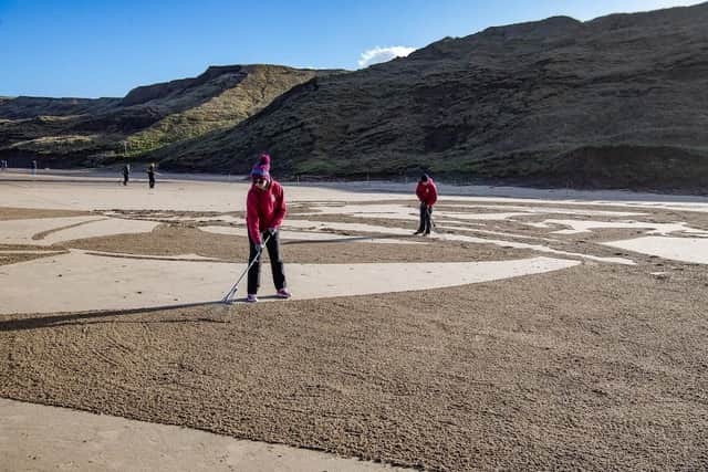 Liz Warrington and Peter McKenna from Sand in Your Eye work on the sand art. (Pic credit: Tony Johnson)