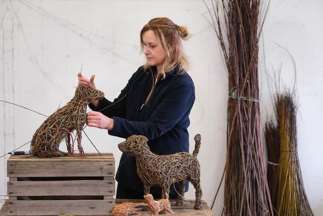 Whitby's Emma Stothard puts the finishing touches to willow sculptures of the Jack Russell Dogs, Beth and Bluebell, which are owned by The King and Queen.