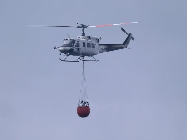 A helicopter helps to tackle the fire