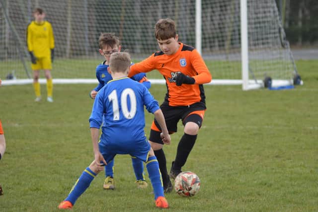 Heslerton Heroes Under-13s (orange kit) in action against Eastfield. PHOTO: CHERIE ALLARDICE