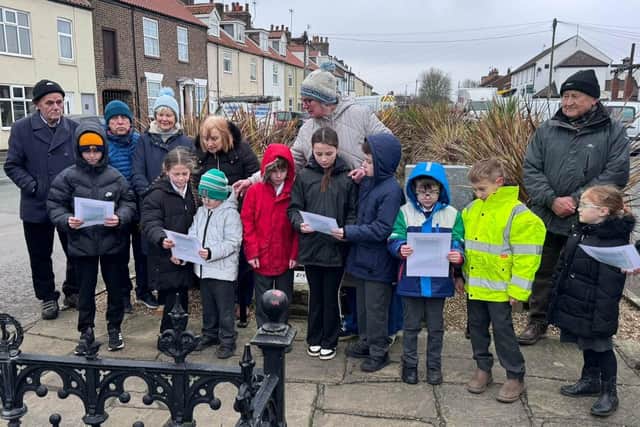 Children from Flamborough CofE Primary School read a poem entitled The Fisherman's Prayer. Photo: Mark Smales