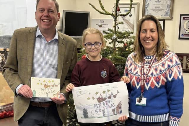 Pictured with Charlie Dewhirst MP is last year’s Christmas card winner Megan Kilkenny.